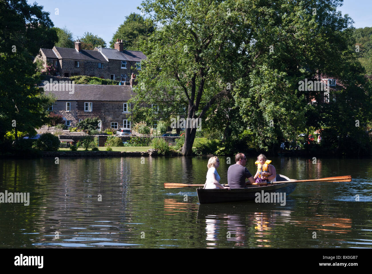 Family rowing on the River Derwent at the River Gardens, Belper, Derbyshire, England Stock Photo