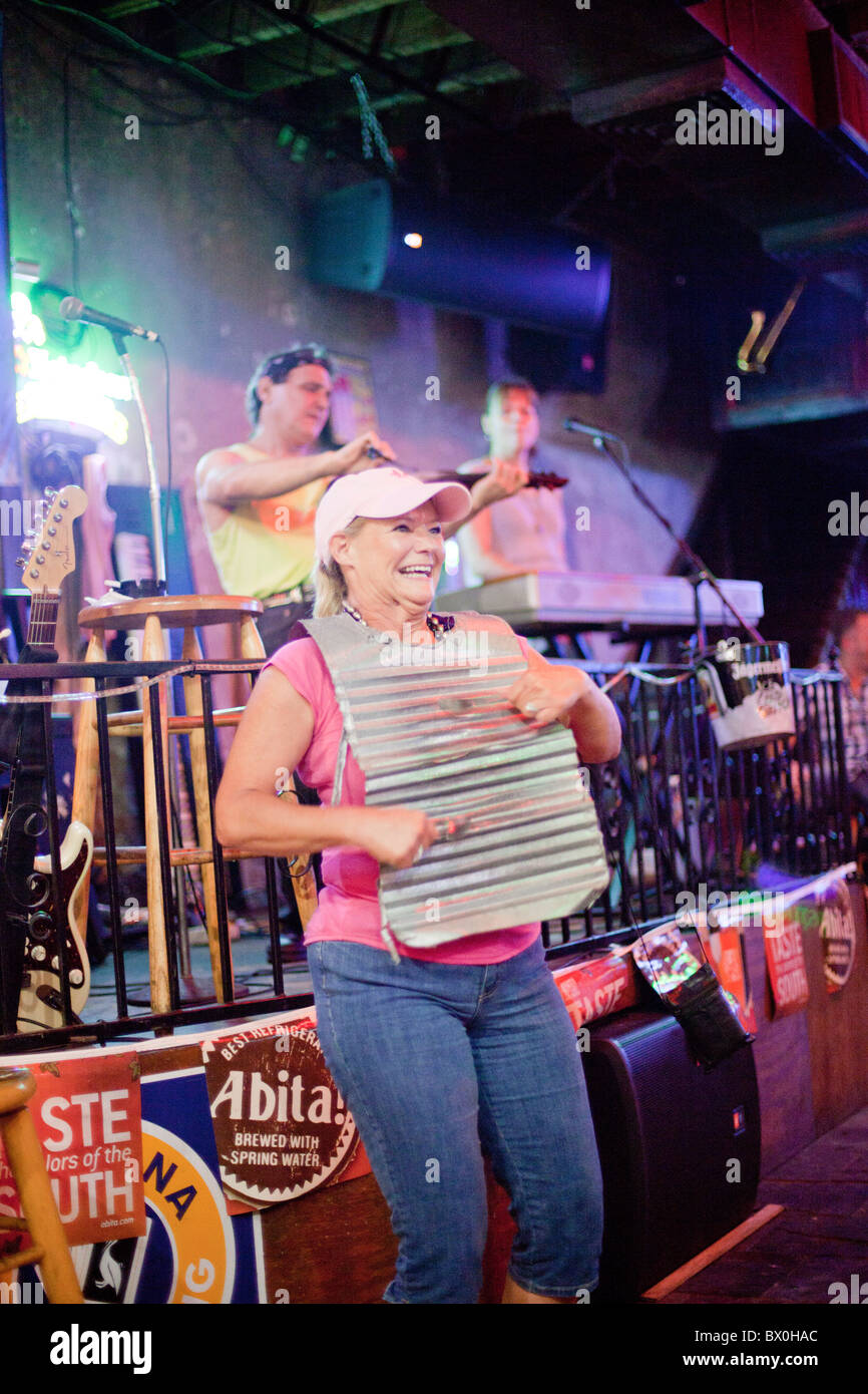 Pulled in from the audience, a tourist in New Orleans plays the