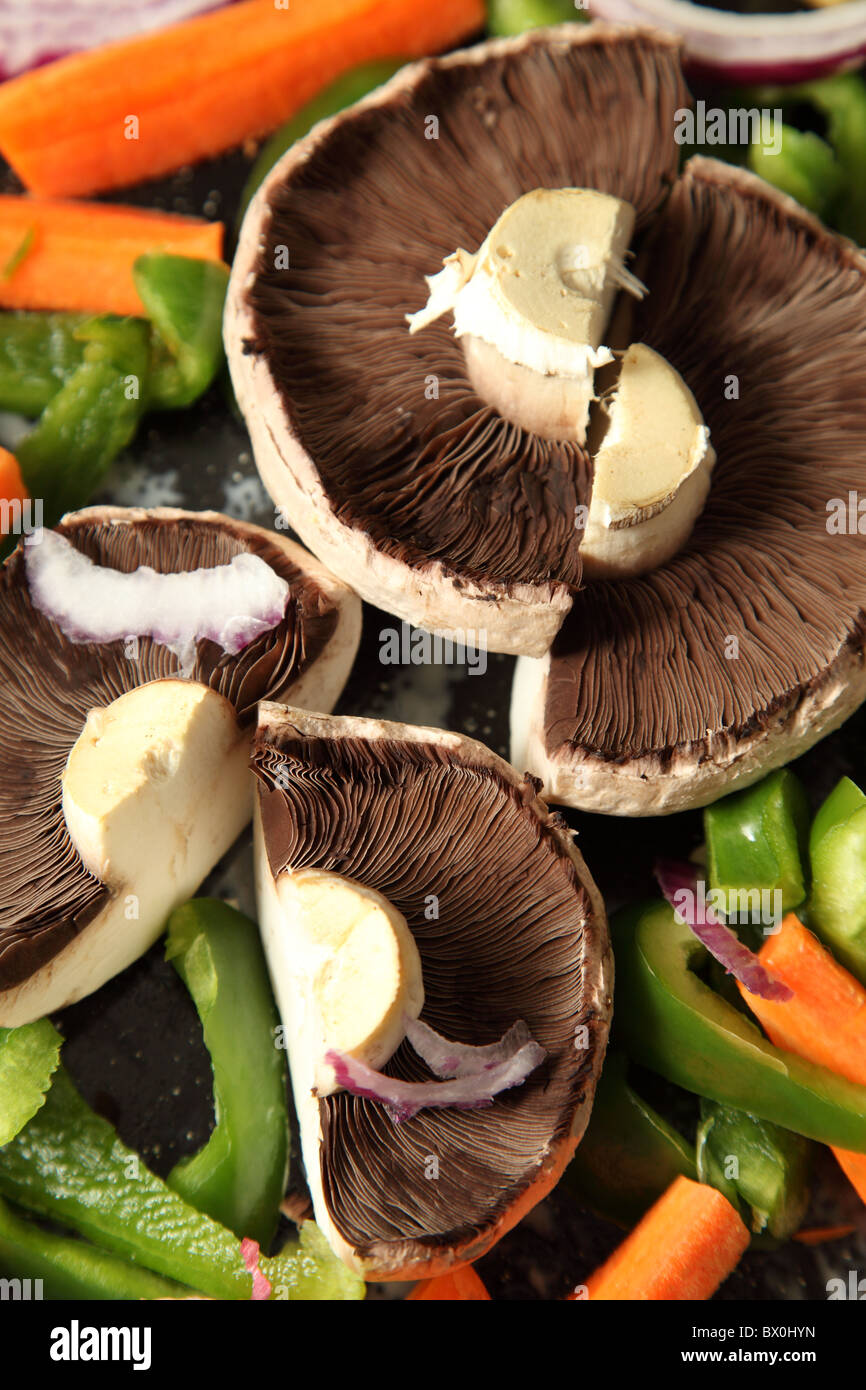 Mushrooms and green peppers prepared for roasting. Stock Photo