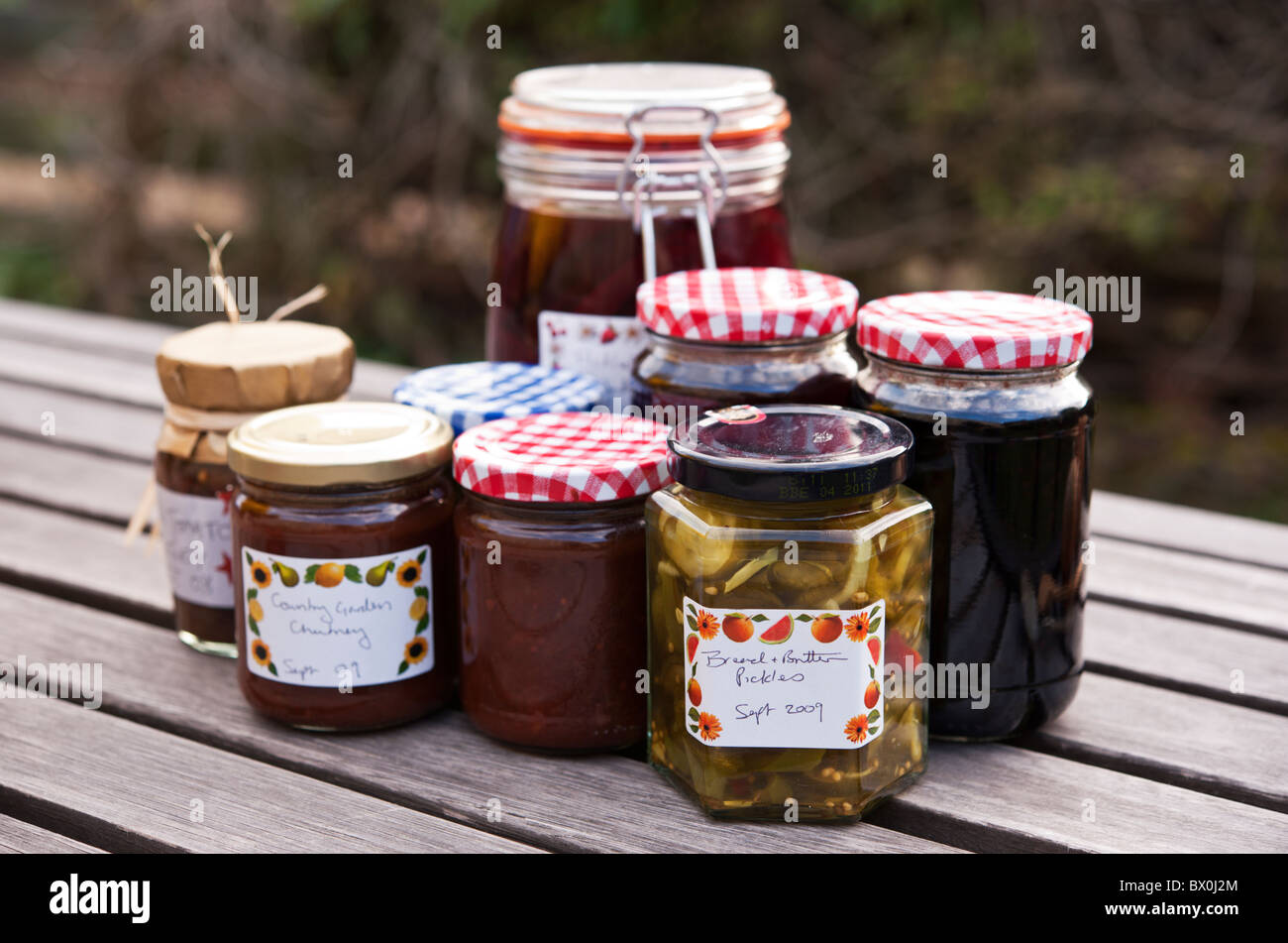 A selection of homemade chutneys, pickles, and preserves harvested from an organic allotment. Stock Photo
