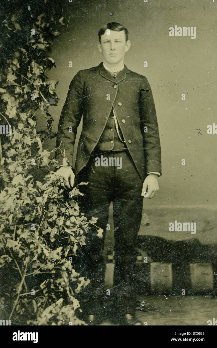 young man wearing four button sack coat black and white tin type photograph 1860s to 1870s fashion vertical portrait americana Stock Photo