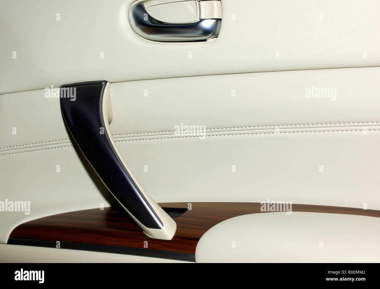 Interior of modern japanese car. Door made of leather, wood and aluminium. As background or backdrop. Stock Photo