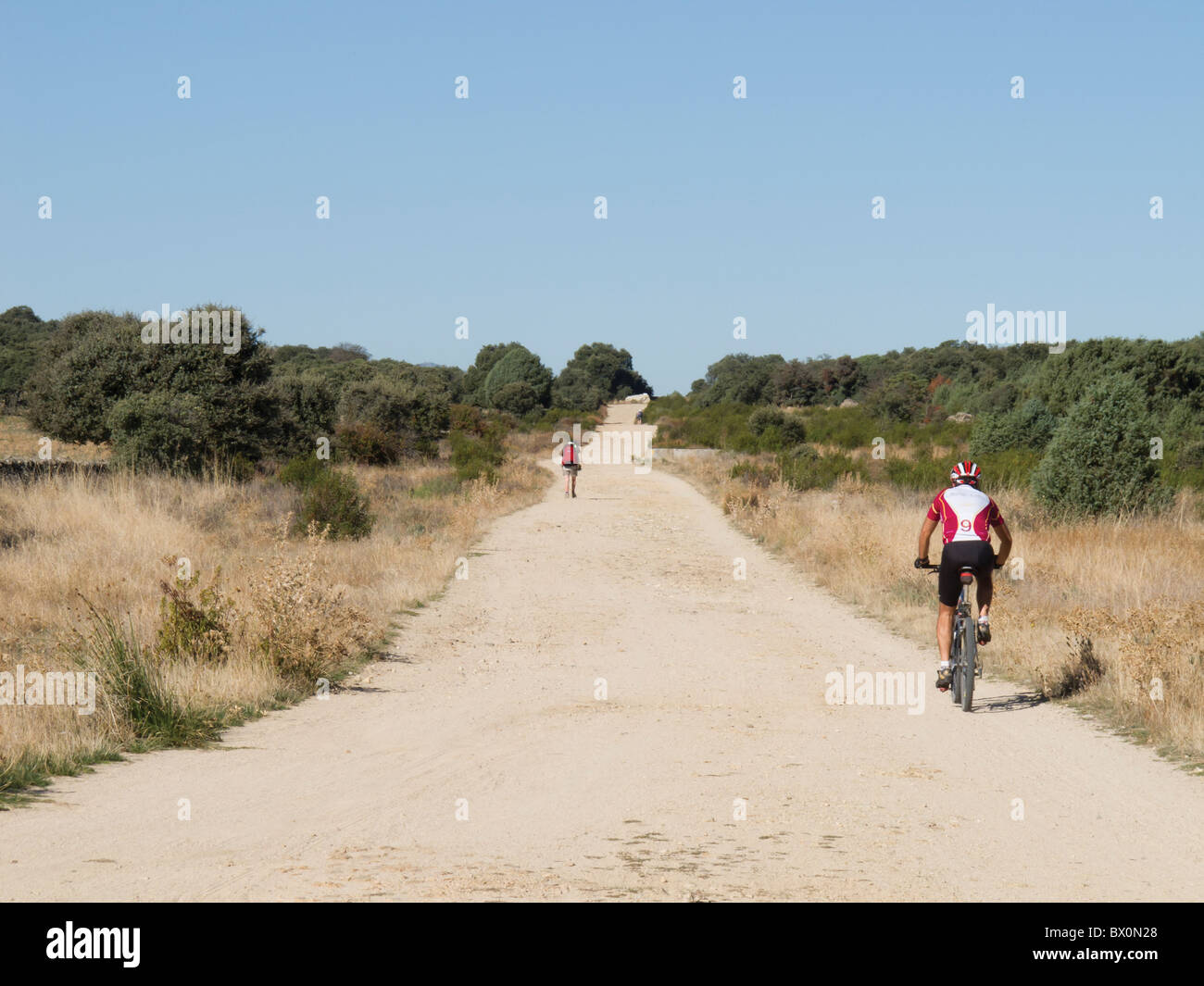 Walker and cyclist on Camino de Santiago, Spain Stock Photo