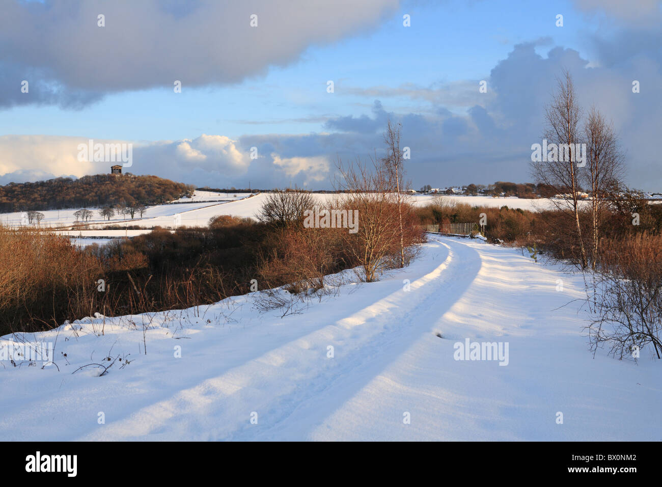 The snow covered tracks of the Leamside Line with Penshaw Monument in the background, England, UK Stock Photo