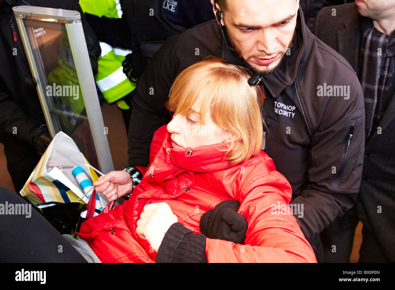 Private security guards remove a ukuncut protester from Topshop on Oxford  Street Stock Photo - Alamy