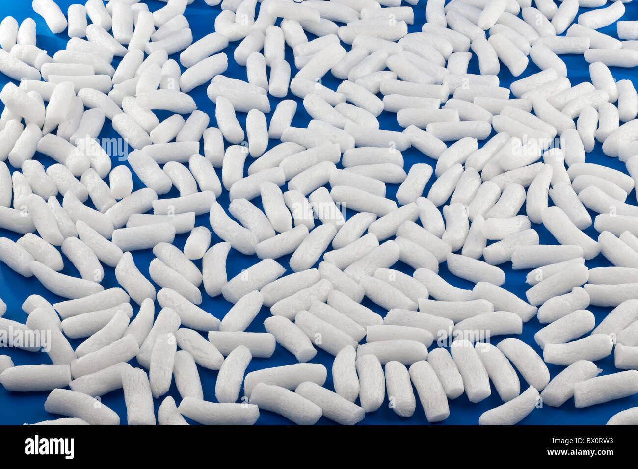 White sticks of foam on a blue background Stock Photo