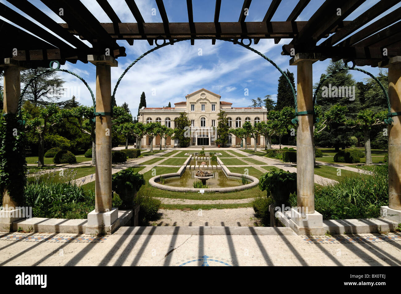 Bouillons Château and Formal French Garden with Pool Framed by Pergola, Source Perrier, Vergèze nr Nimes France Stock Photo
