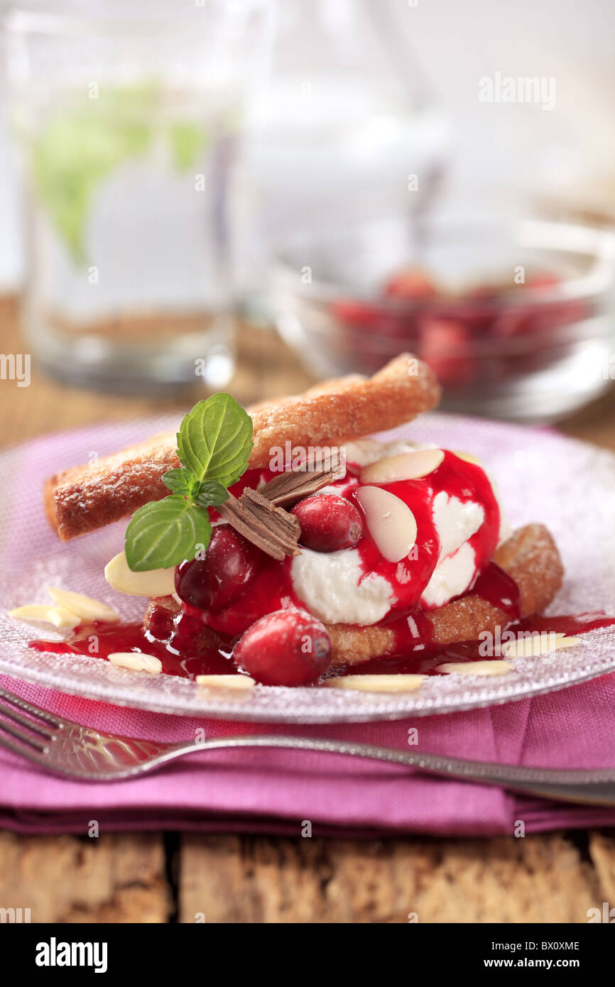 Dessert - Waffles with cream, cranberries and syrup Stock Photo