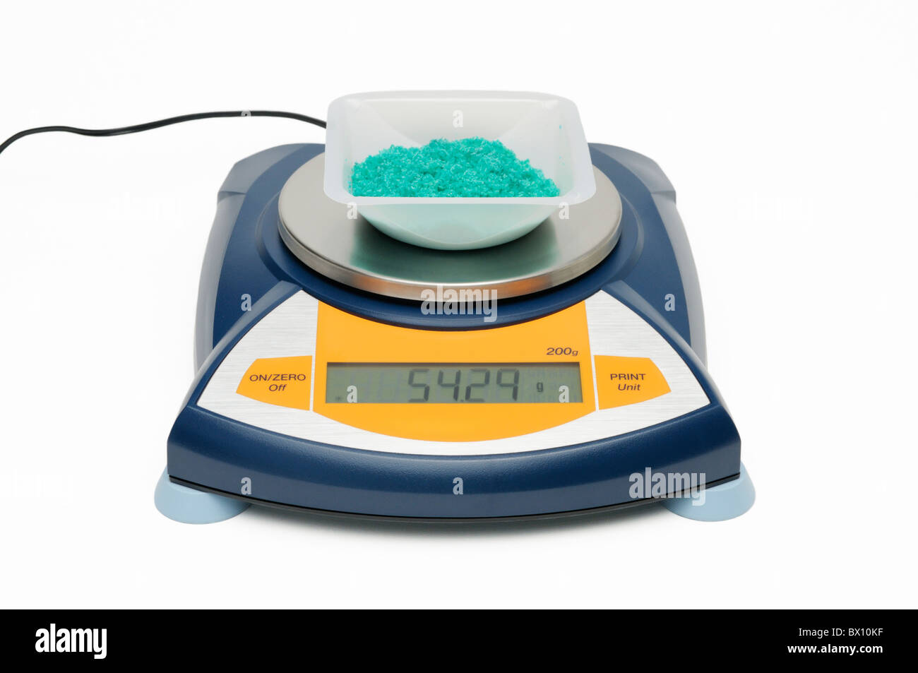 Measuring the mass of a chemical (Cupric Chloride dihydrate crystals) with electronic balance Stock Photo