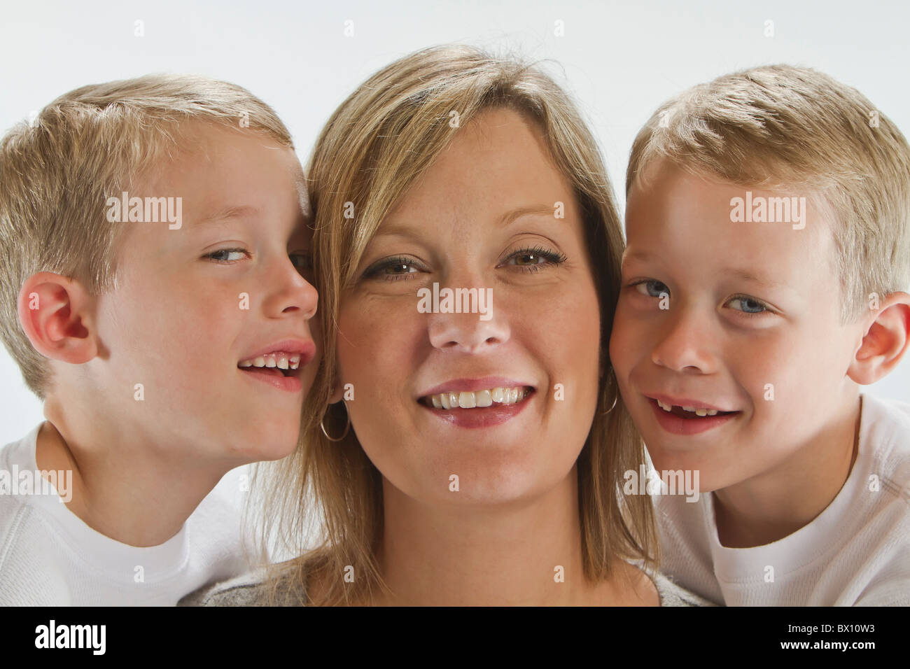 Happy Mom with 6 years old identical twins Stock Photo