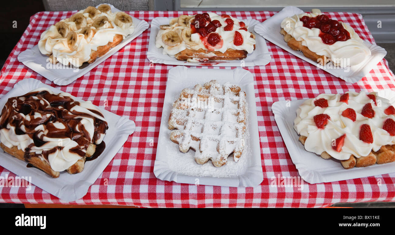 Bruges, East Flanders, Belgium, Europe. Display of Belgian waffles on a table with a checkered cloth outside a café Stock Photo