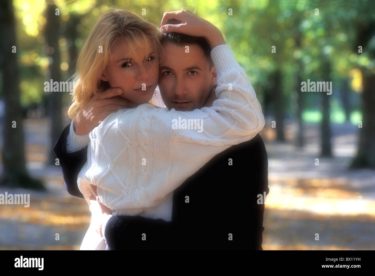 affectionate couple Couple courting love model outside park portrait pullover sweater umschlungen Stock Photo