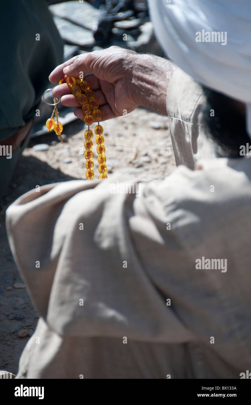 Prayer beads in the hand of Helmand man Stock Photo