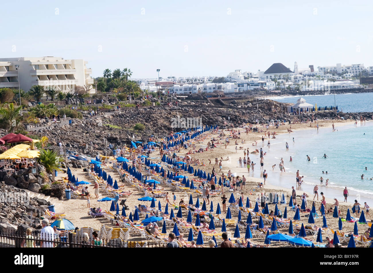 crowded beach beaches lanzarote canary islands isles canaries holiday destination hot sun sunny playa blanca holidaymakers brits Stock Photo