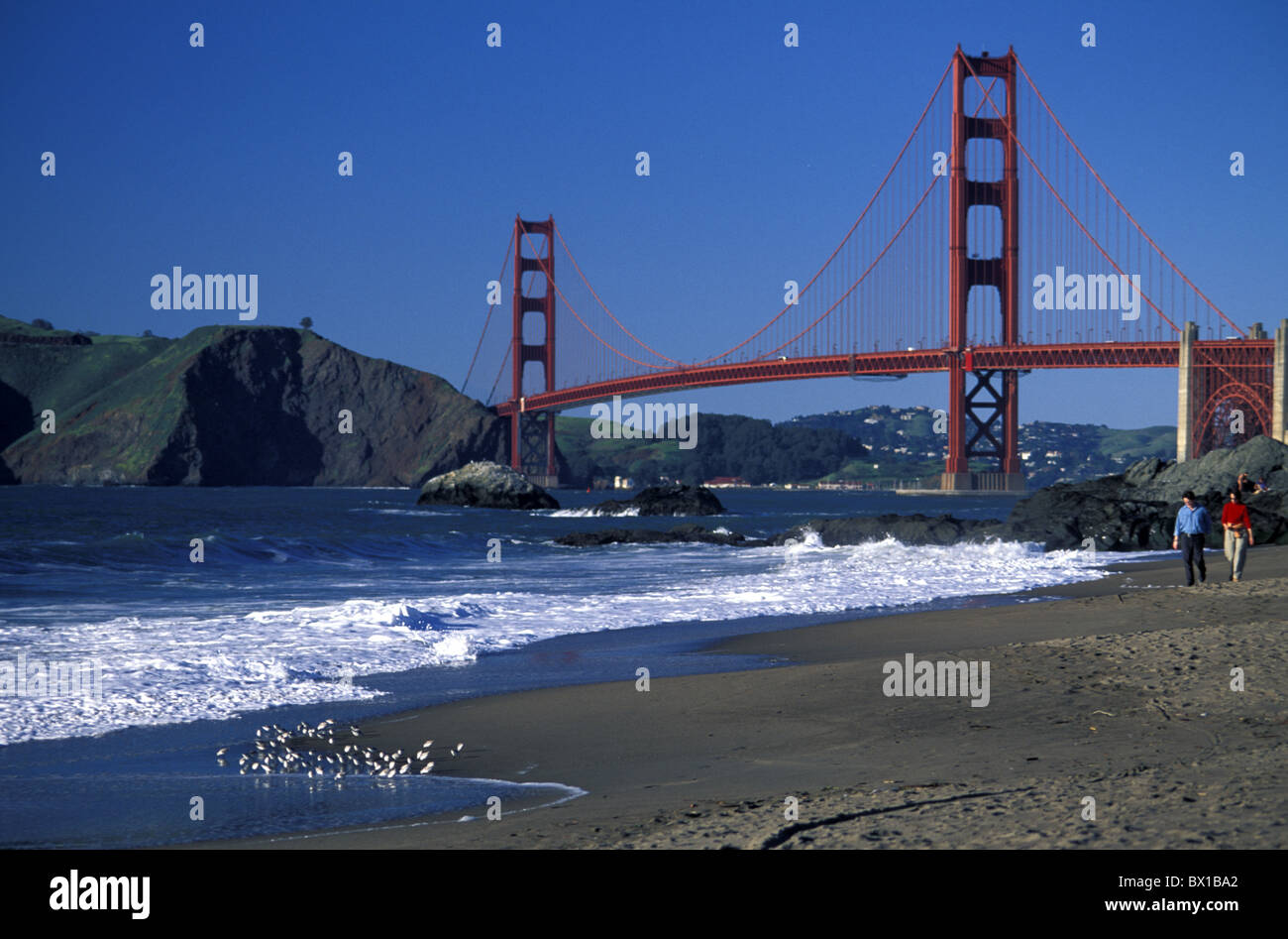 Baker Beach couple walk Golden Gate Bridge California San Francisco USA ...