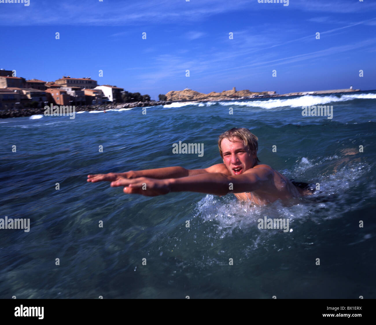 Child man boy teenager youngsters swimming sea bathing holidays vacation fun joke Mediterranean Sea Franc Stock Photo