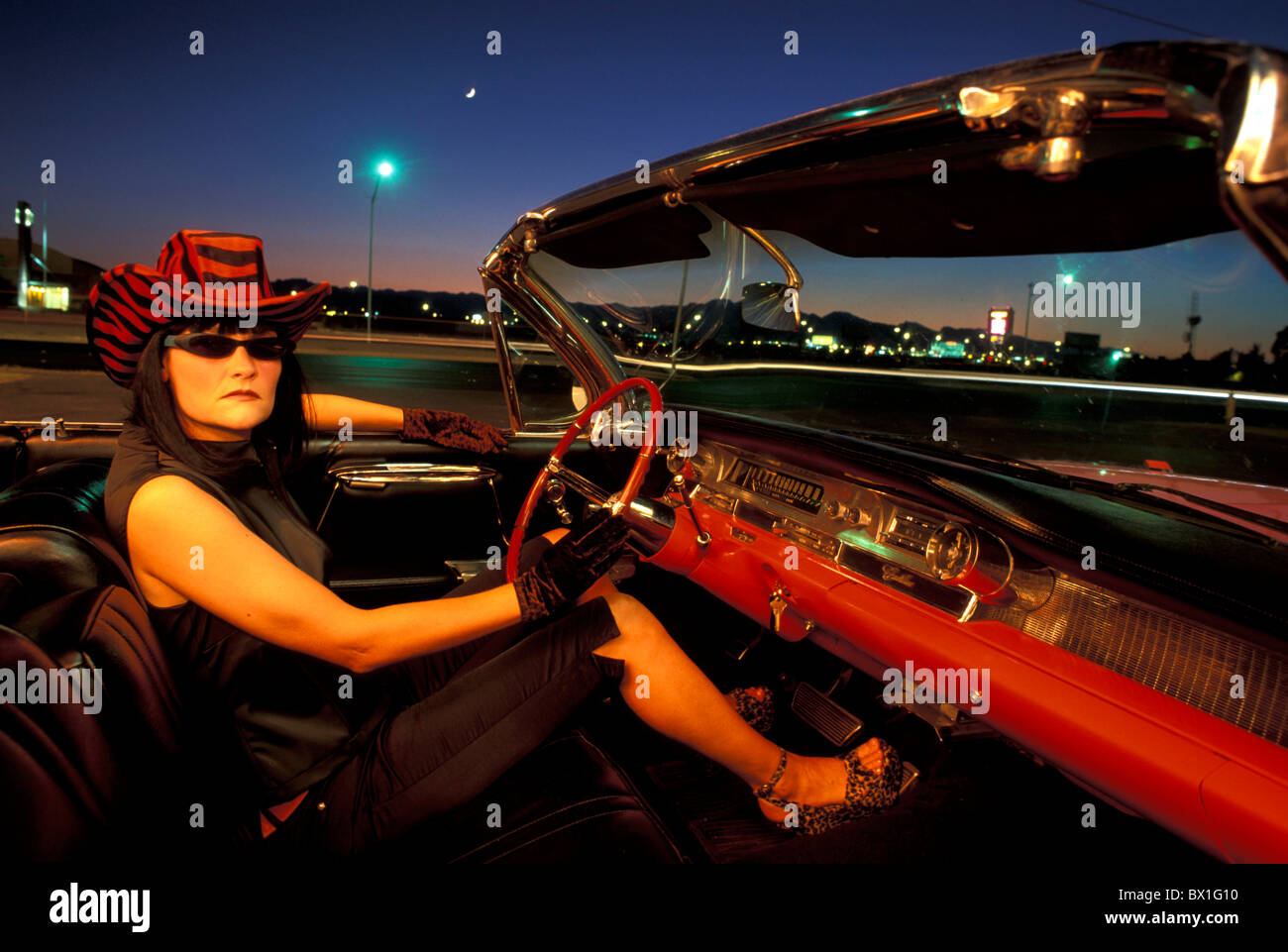 1962 Pink Cadillac Convertible Nevada USA America United States woman nightlife night lifestyle hat cowboy Stock Photo