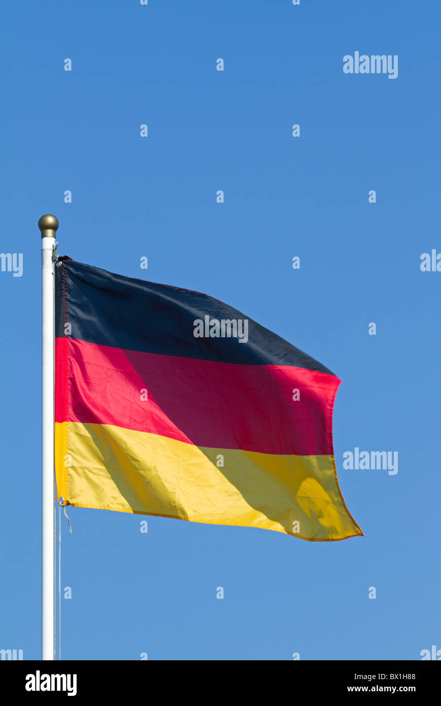 Breezing Germany flag with blue sky Stock Photo