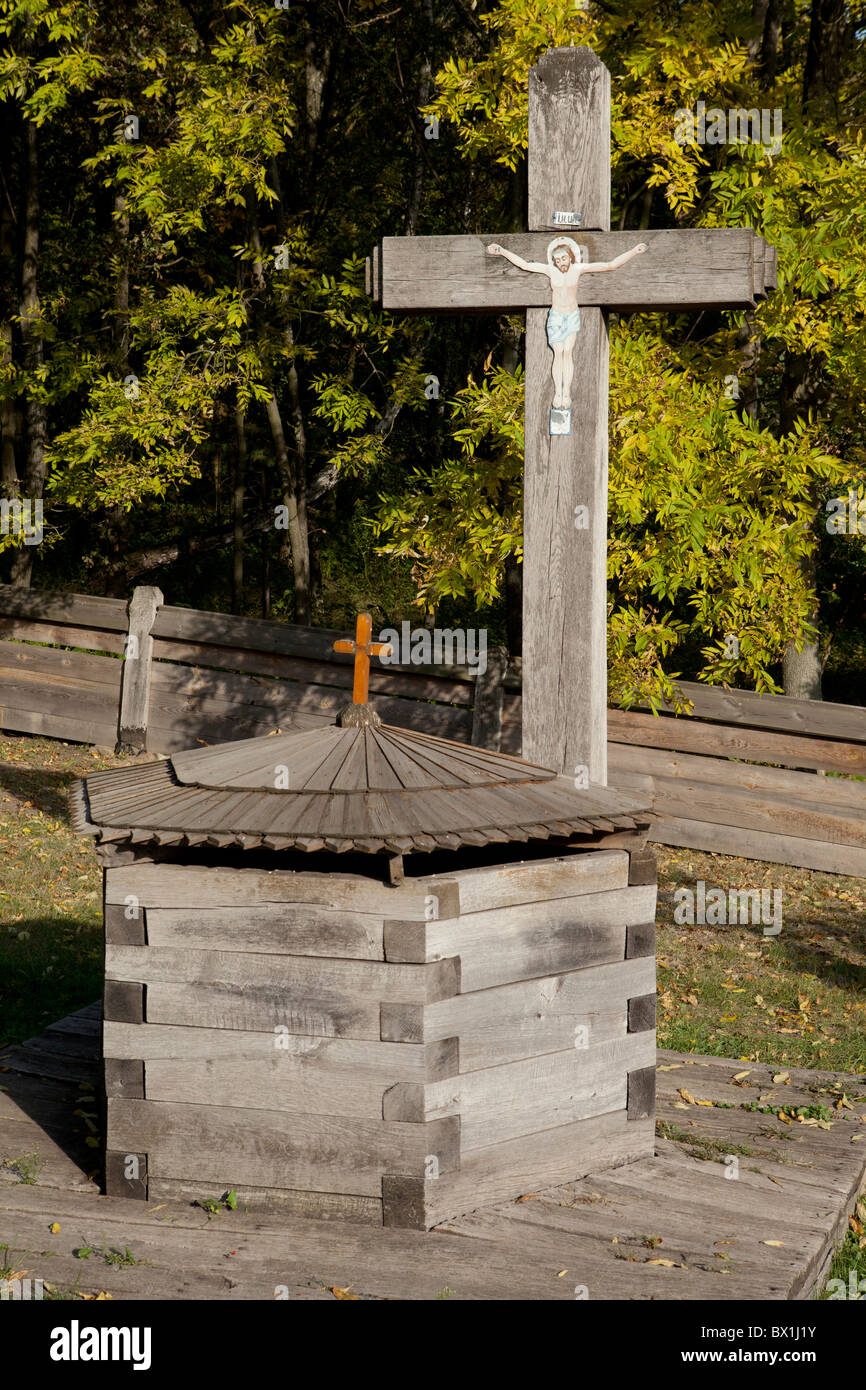 Wooden cross and well at Pyrohovo (State Museum of Folk Architecture and Life of Ukraine) in Kiev, Ukraine Stock Photo
