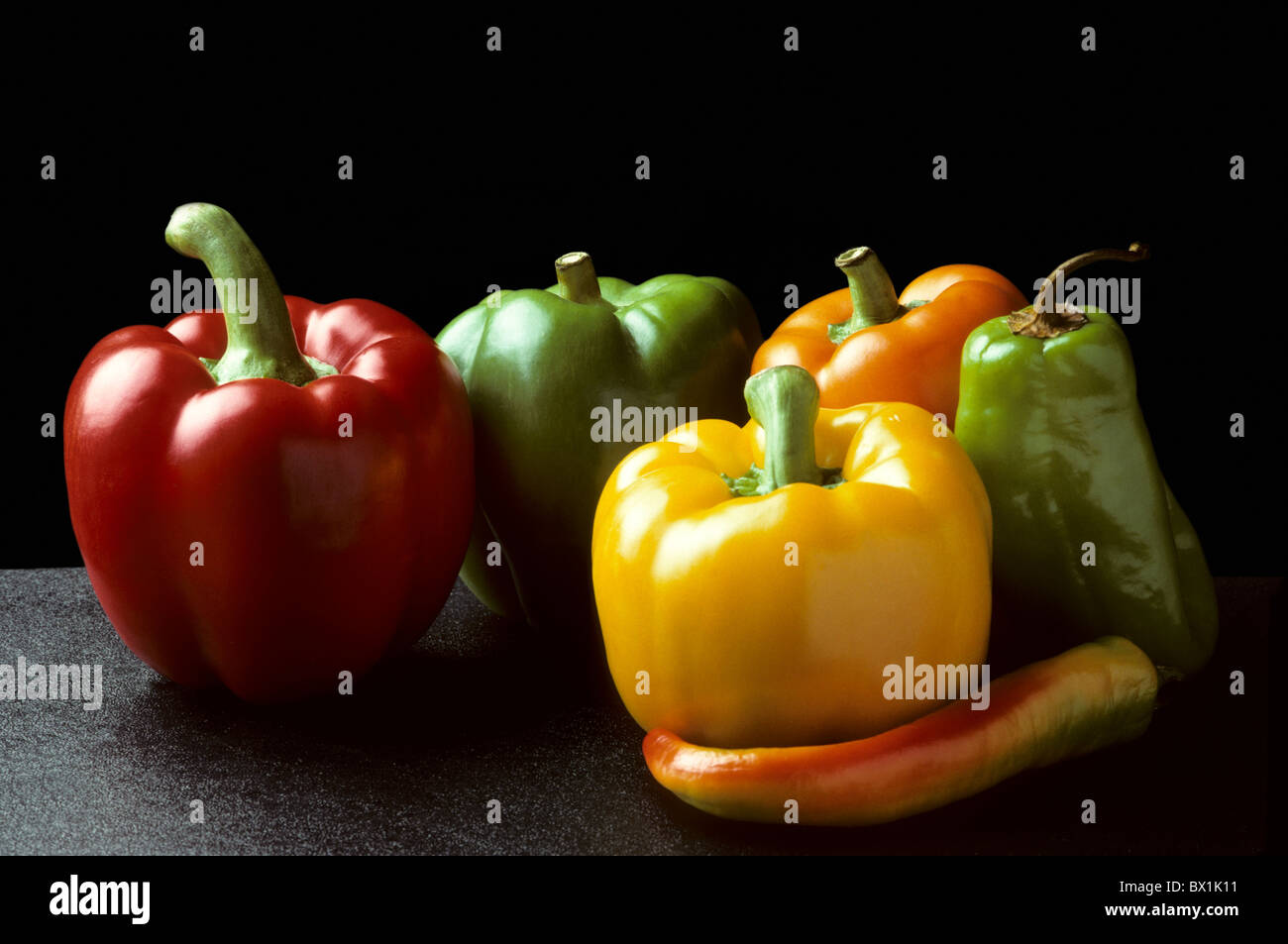Bell and Chili peppers against black background Horizontal Stock Photo