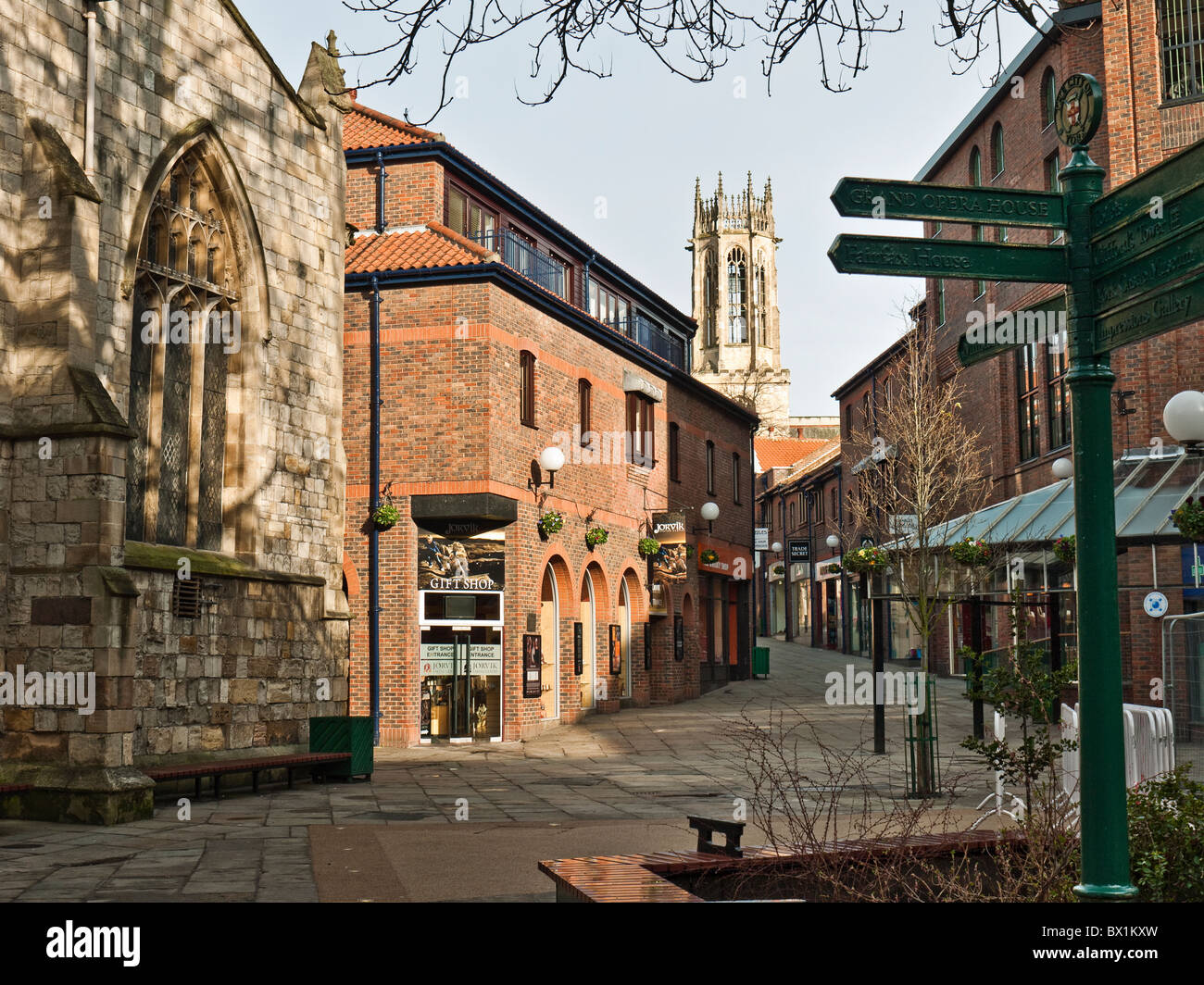 Coppergate Walk with Jorvik viking museum and signpost in early morning winter sunshine, City of York, Yorkshire, UK Stock Photo
