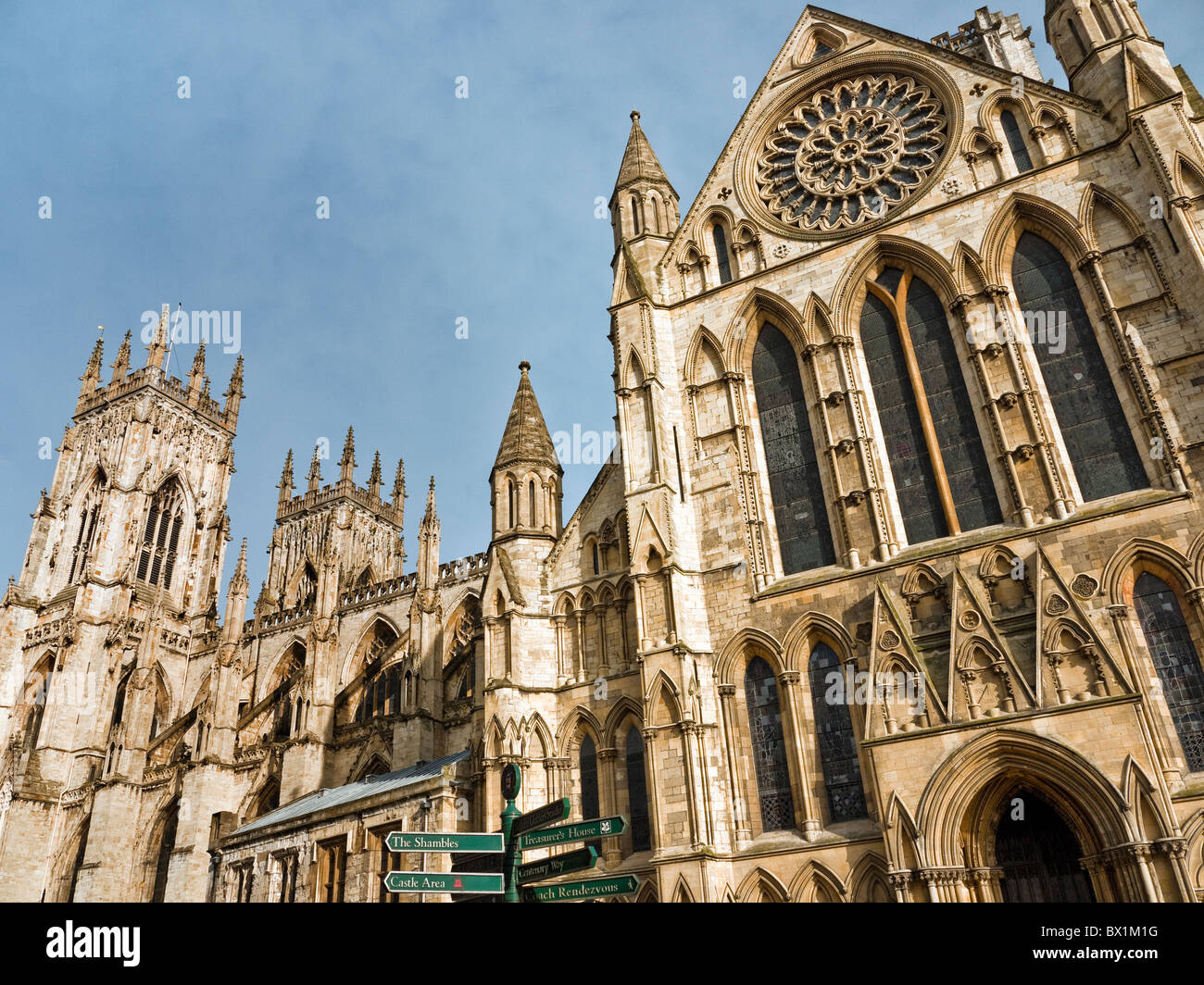 York Minster showing the entrance at the end of the South transept with rose window and signpost, City of York, Yorkshire, UK Stock Photo