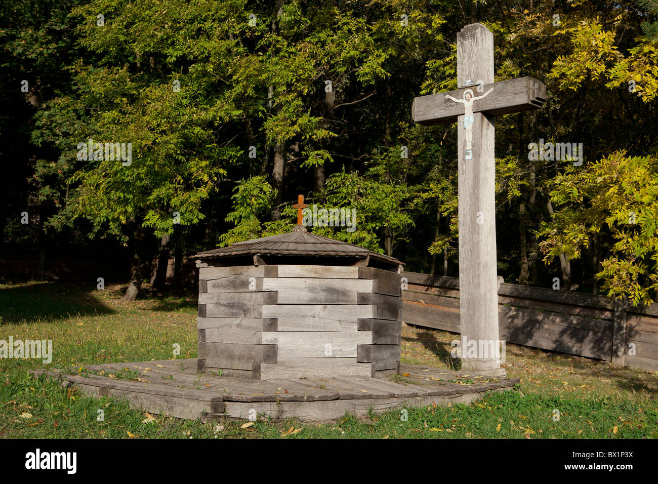 Wooden cross and well at Pyrohovo (State Museum of Folk Architecture and Life of Ukraine) in Kiev, Ukraine Stock Photo