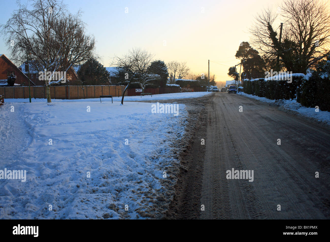 Snow covered verges and road looking into the village, Lees Road
