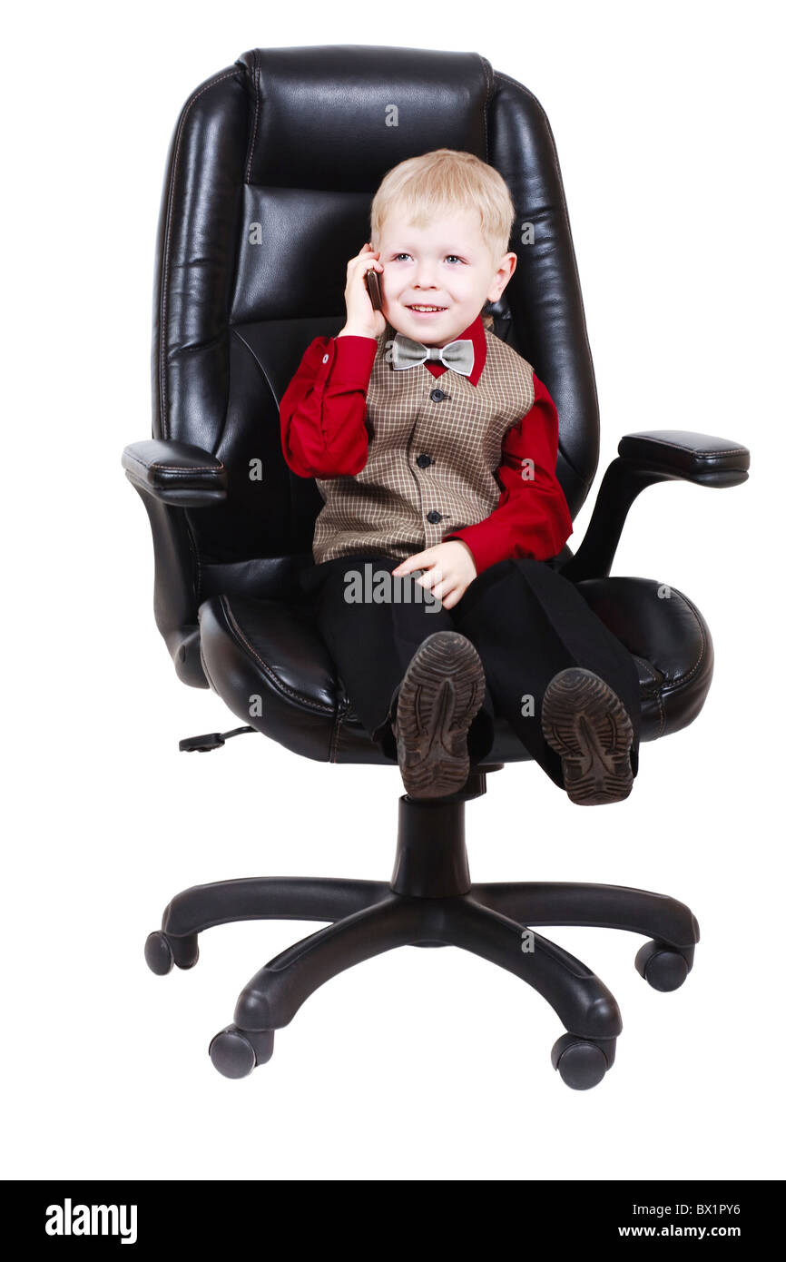 Child businessman boss calling by phone Stock Photo