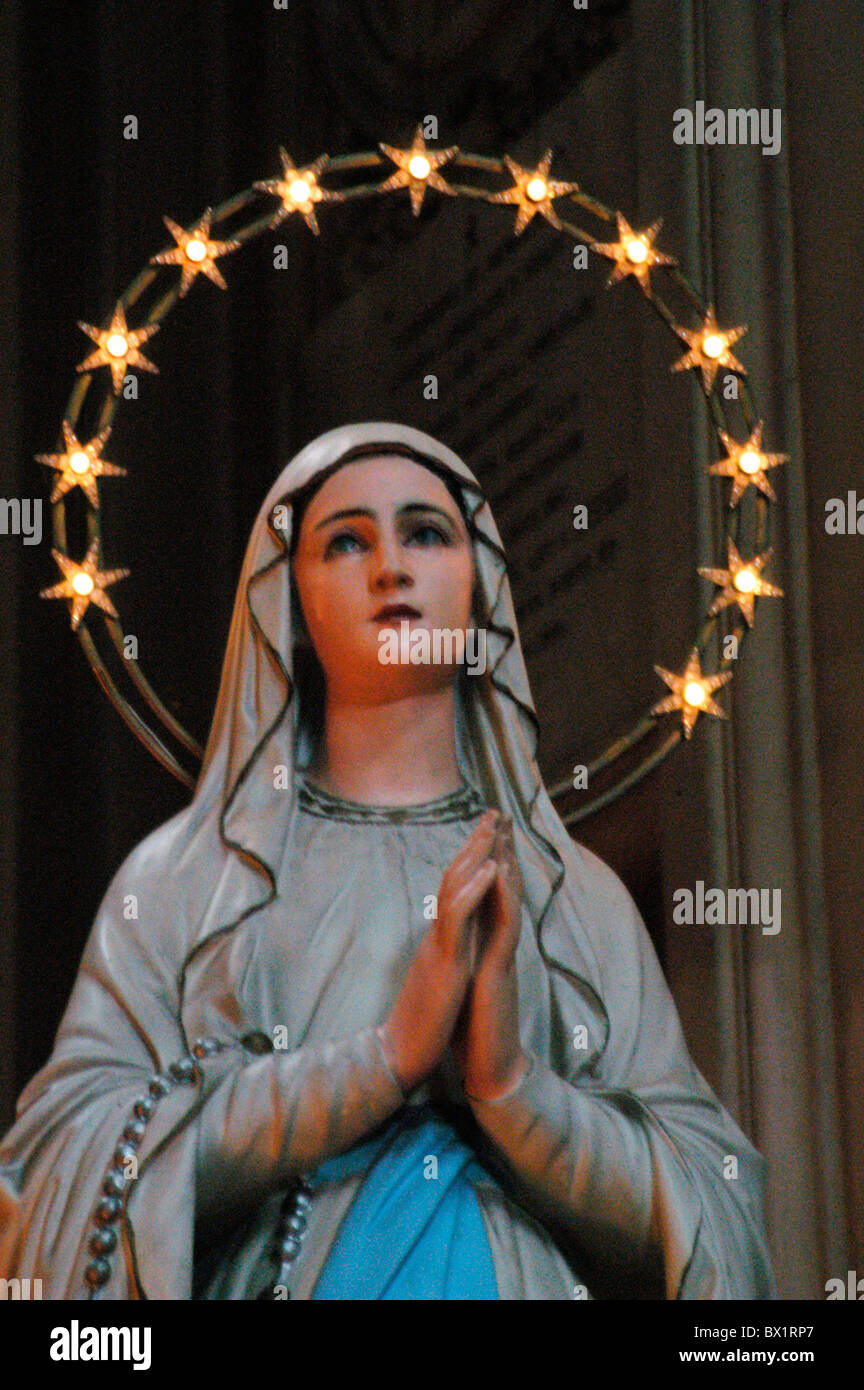 Christianity figure halo Italy Europe kitsch lights Madonna pray reciting religion Rome sculpture stars Stock Photo