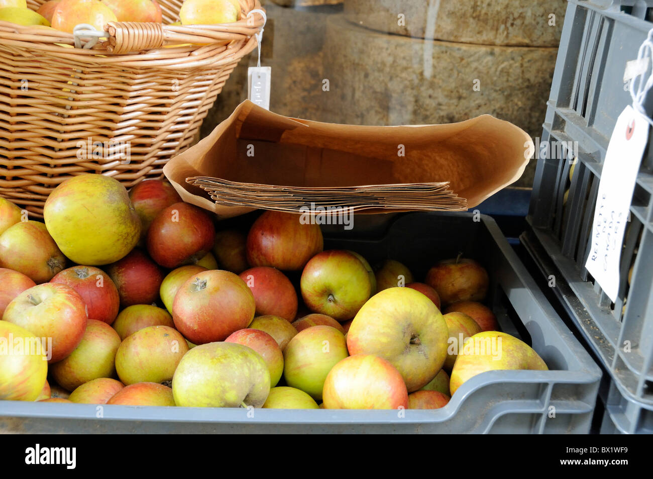 Cox apples for sale outside shop with brown paper bags Stock Photo