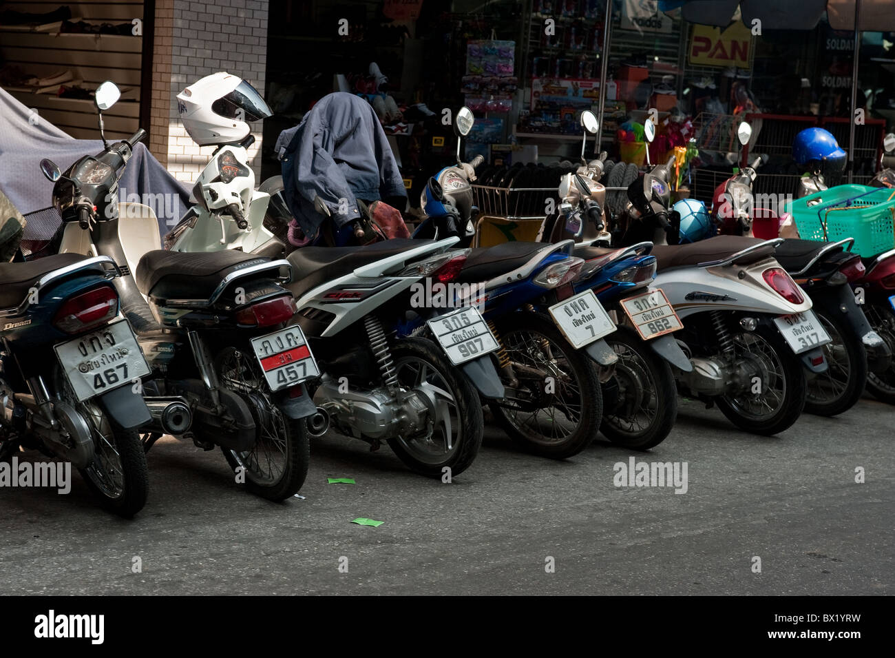 Motorbikes parked at the side of a street in Chiang Mai in Thailand