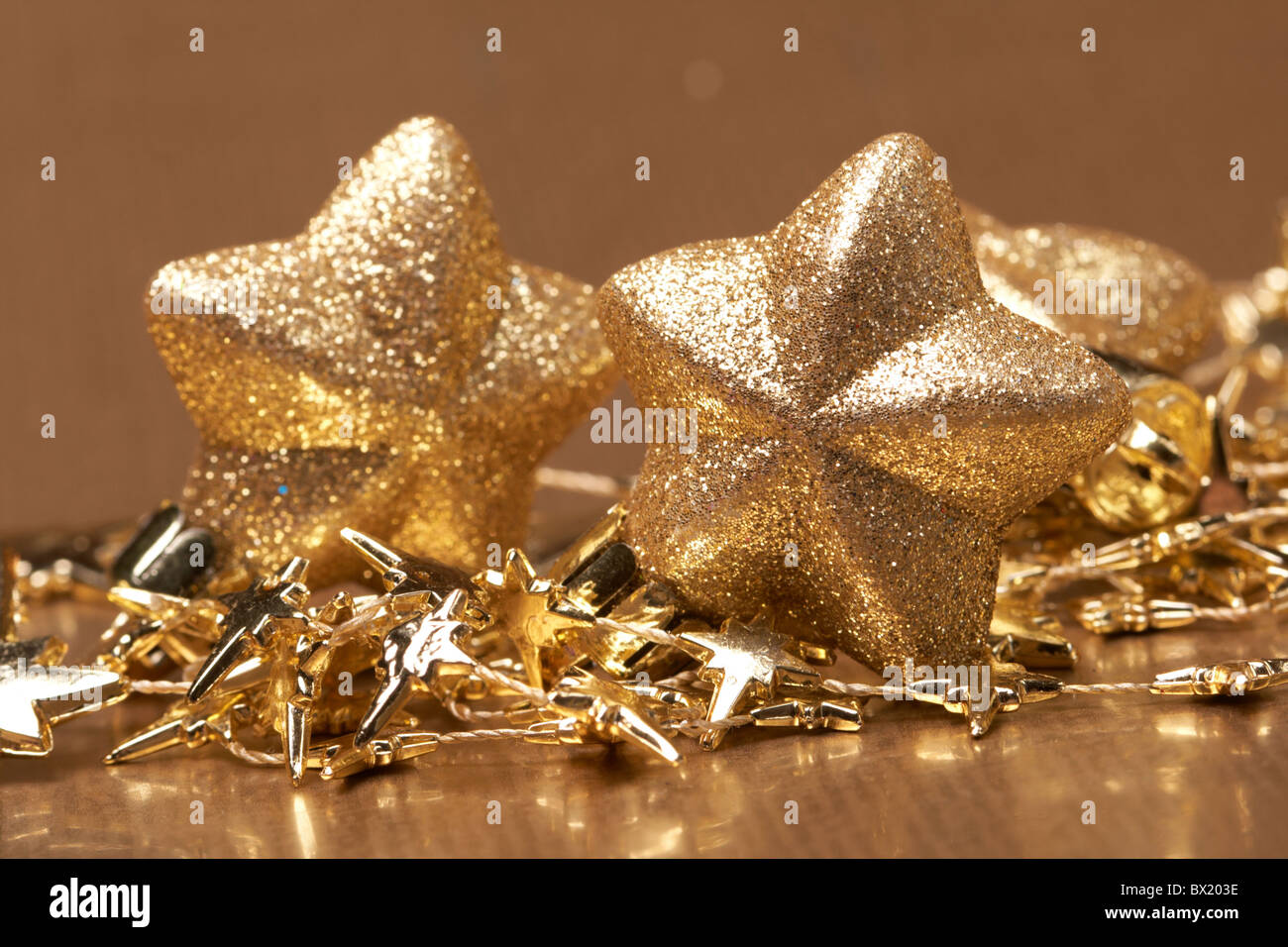Christmas gold stars on the gold background Stock Photo - Alamy