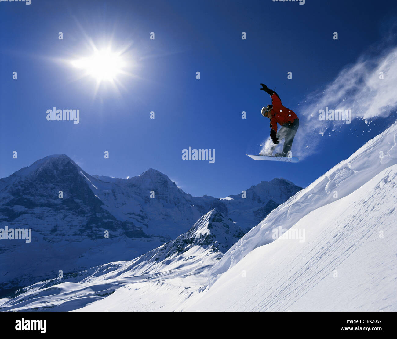 Winter sports snowboard jump snow winter sports action Eiger Monch Jungfrau Snowboarder Mannlichen mountai Stock Photo