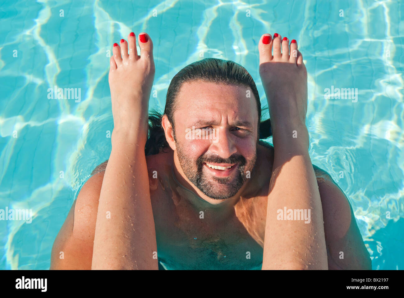 Woman's feet on mans shoulders in the pool Beirut Lebanon Middle East