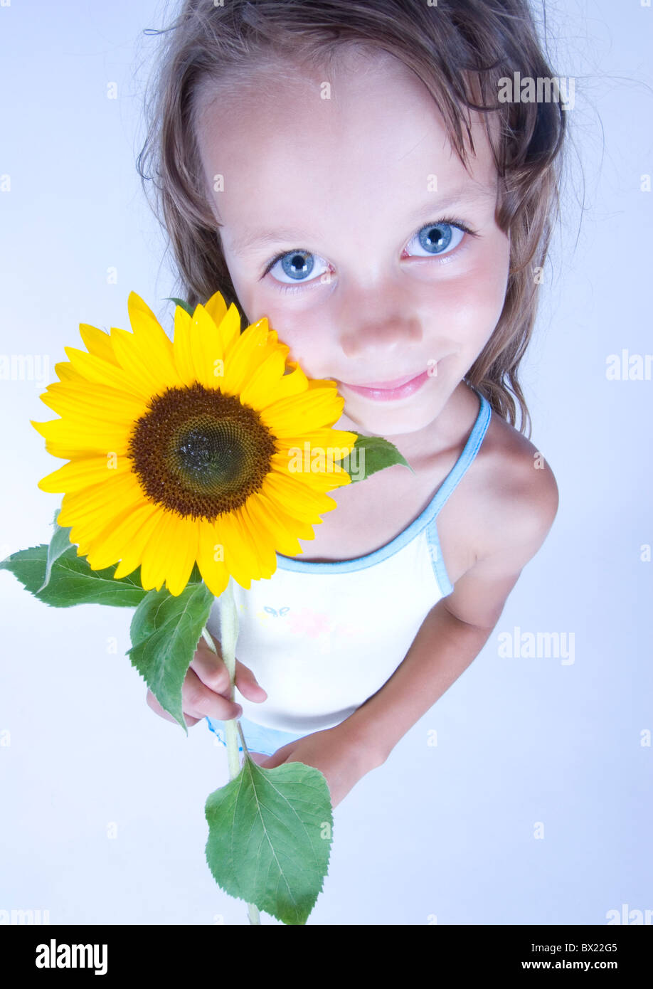 A little girl holding in her hand a beautiful flower Stock Photo - Alamy