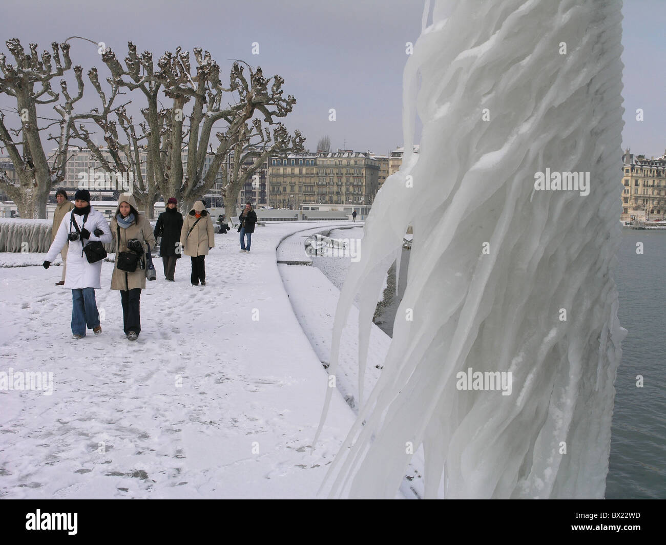 city iced icy frozen ice ice storm lake lake of Geneva Geneva passerby person sculptures shore Switzerl Stock Photo