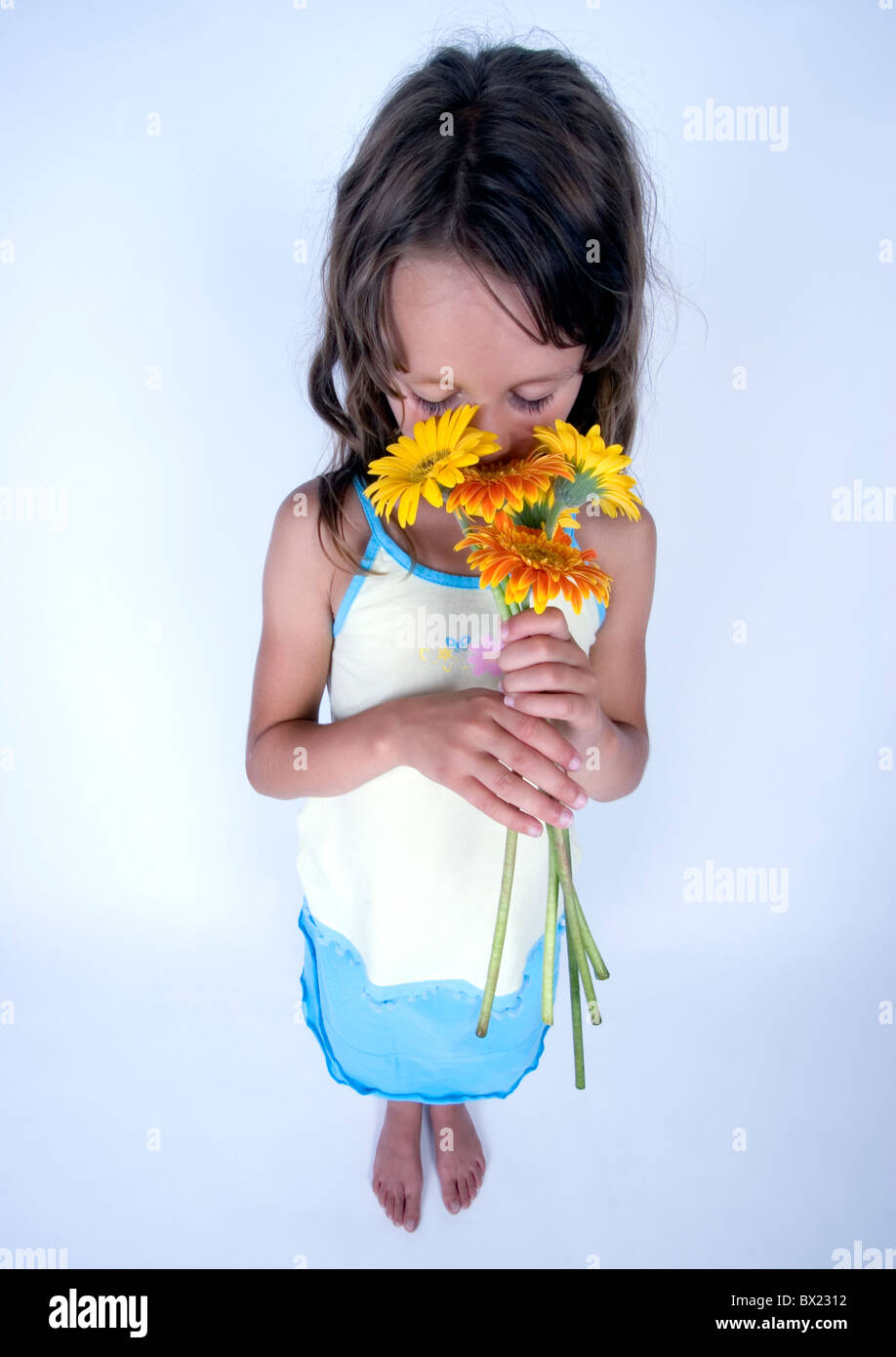 A little girl holding in her hand a beautiful flower Stock Photo - Alamy