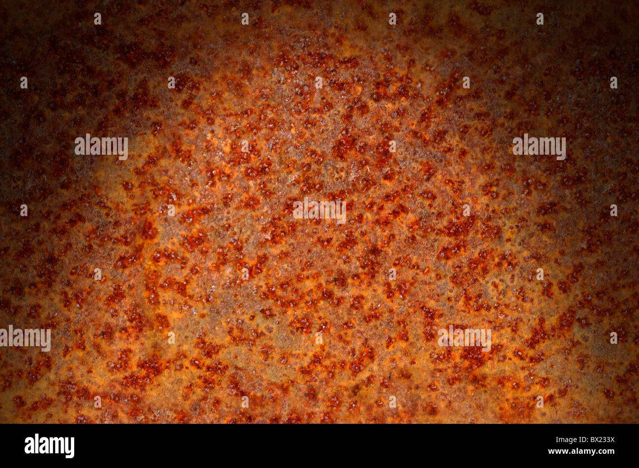 Rusted corroded metal surface dramatically lit from above. Horizontal. Stock Photo