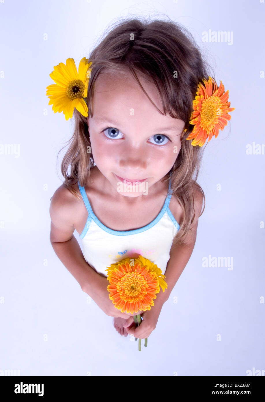 A little girl holding in her hand a beautiful flower Stock Photo - Alamy