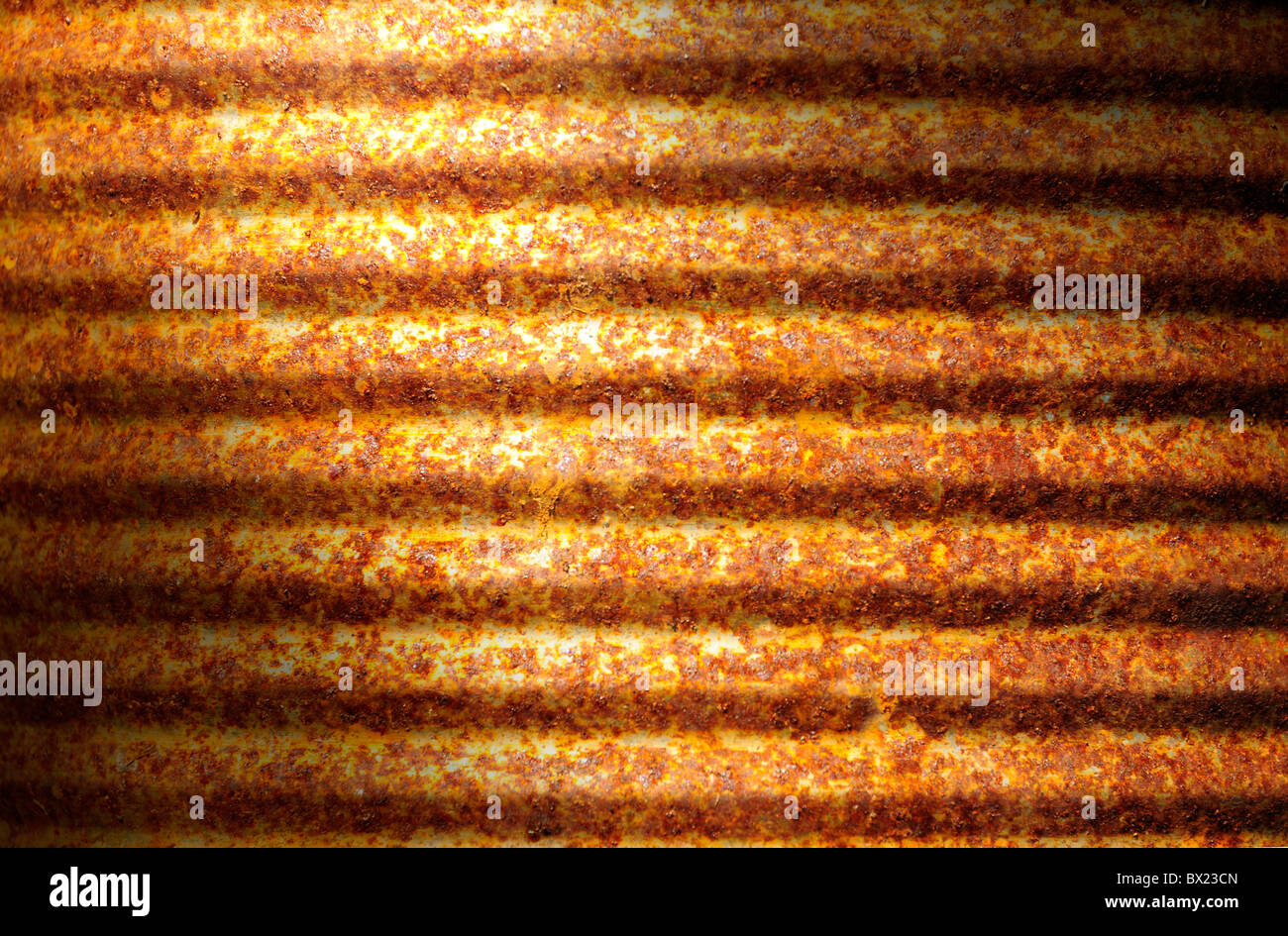 Closeup of rusty corrugated metal can surface lit diagonally Stock Photo