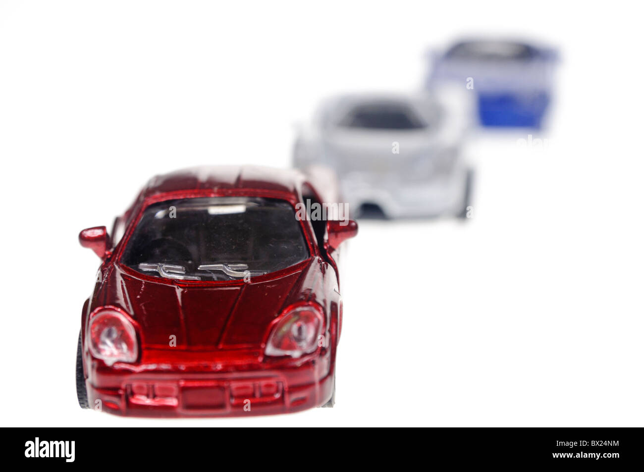 Red, white and blue toy cars in a line Stock Photo