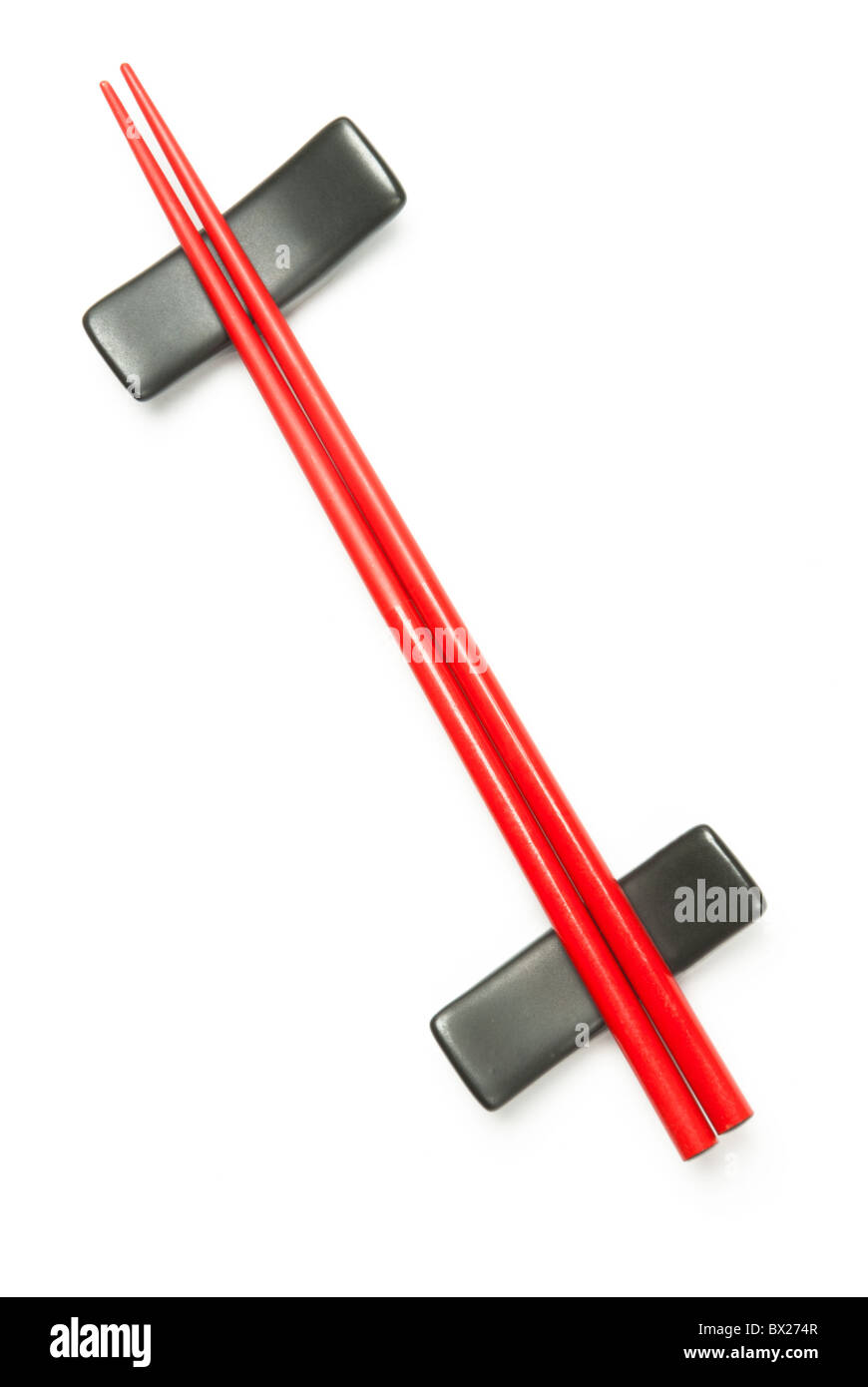 Two red wodden chopstick on holder over white Stock Photo
