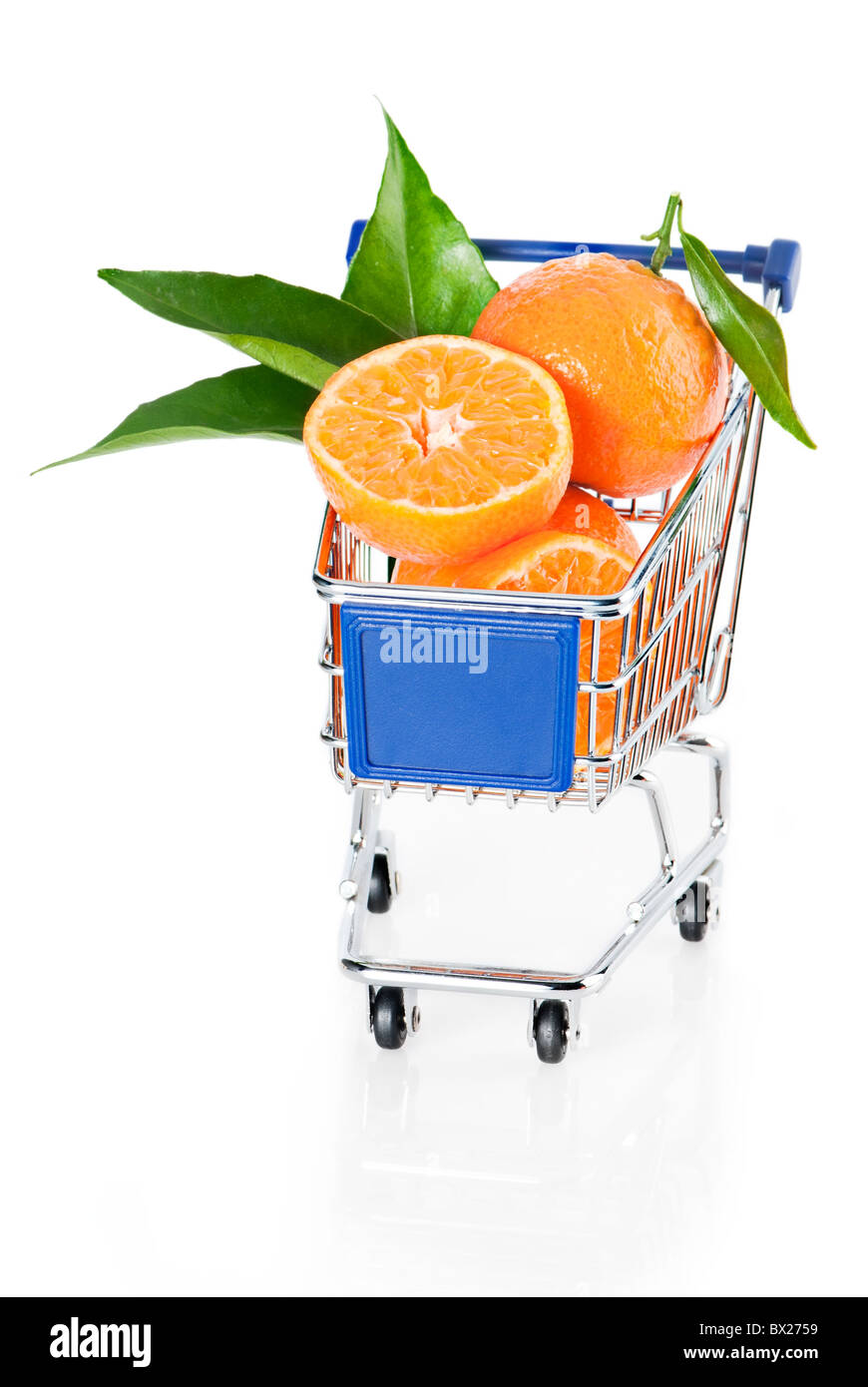 Fruit shopping. Ripe tangerines in shopping cart over white background Stock Photo