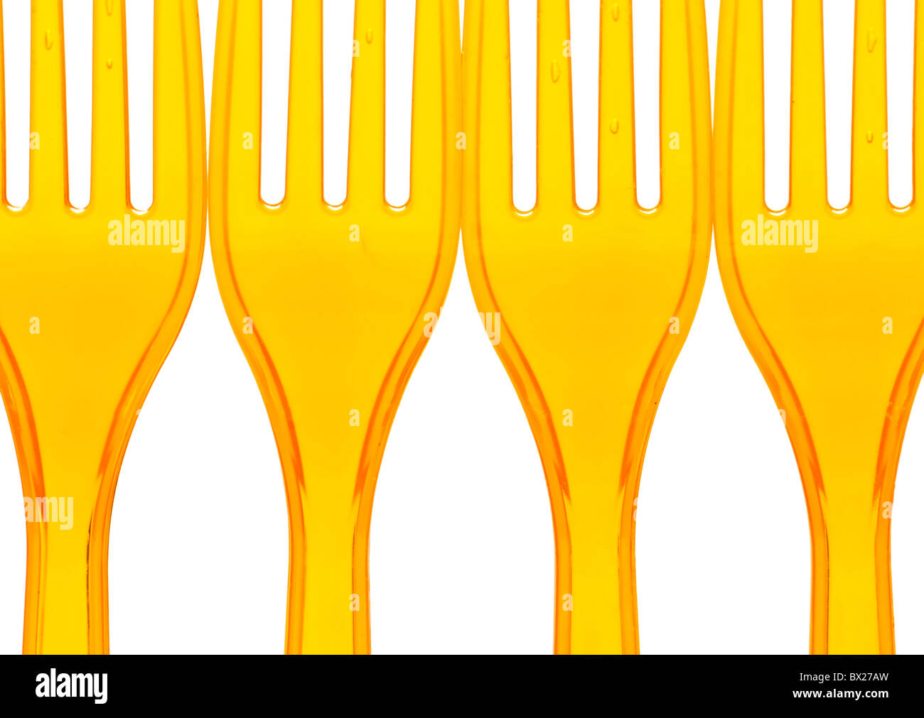 Macro of orange plastic forks over white Stock Photo Alamy
