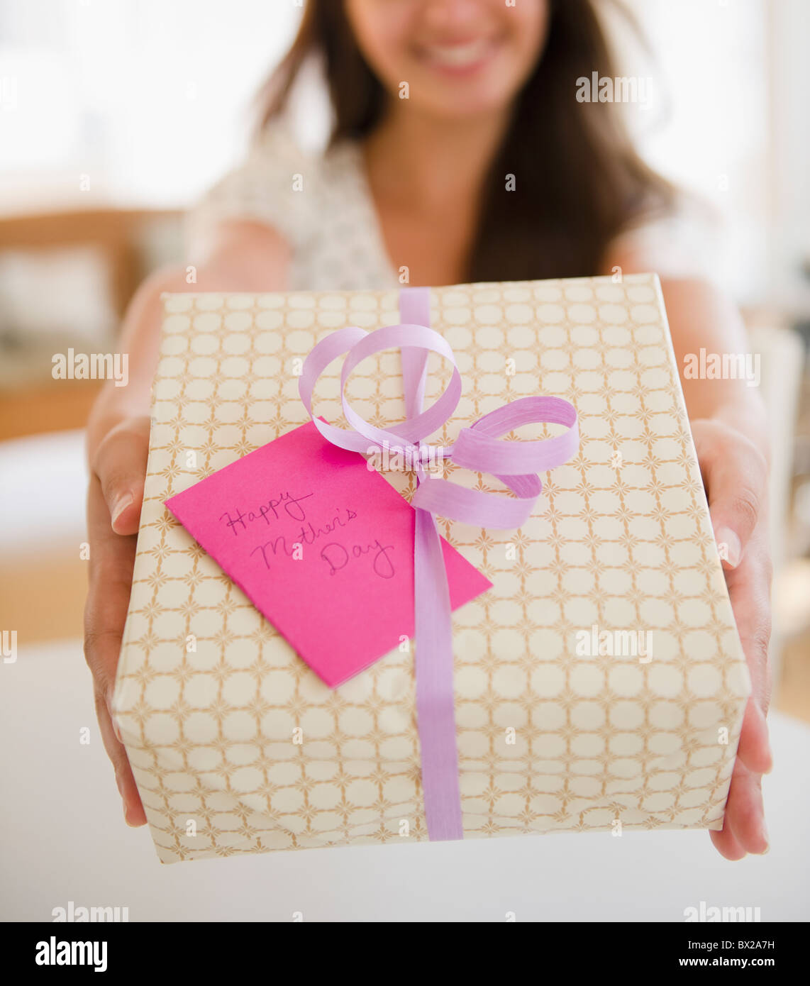 Indian woman holding out Mother's Day gift Stock Photo