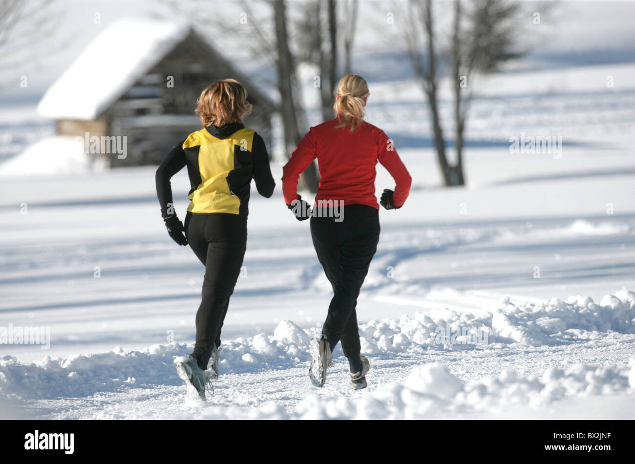 jogging model released mountains running snow sports Alps Two women woman  winter winter sports Europe Stock Photo - Alamy