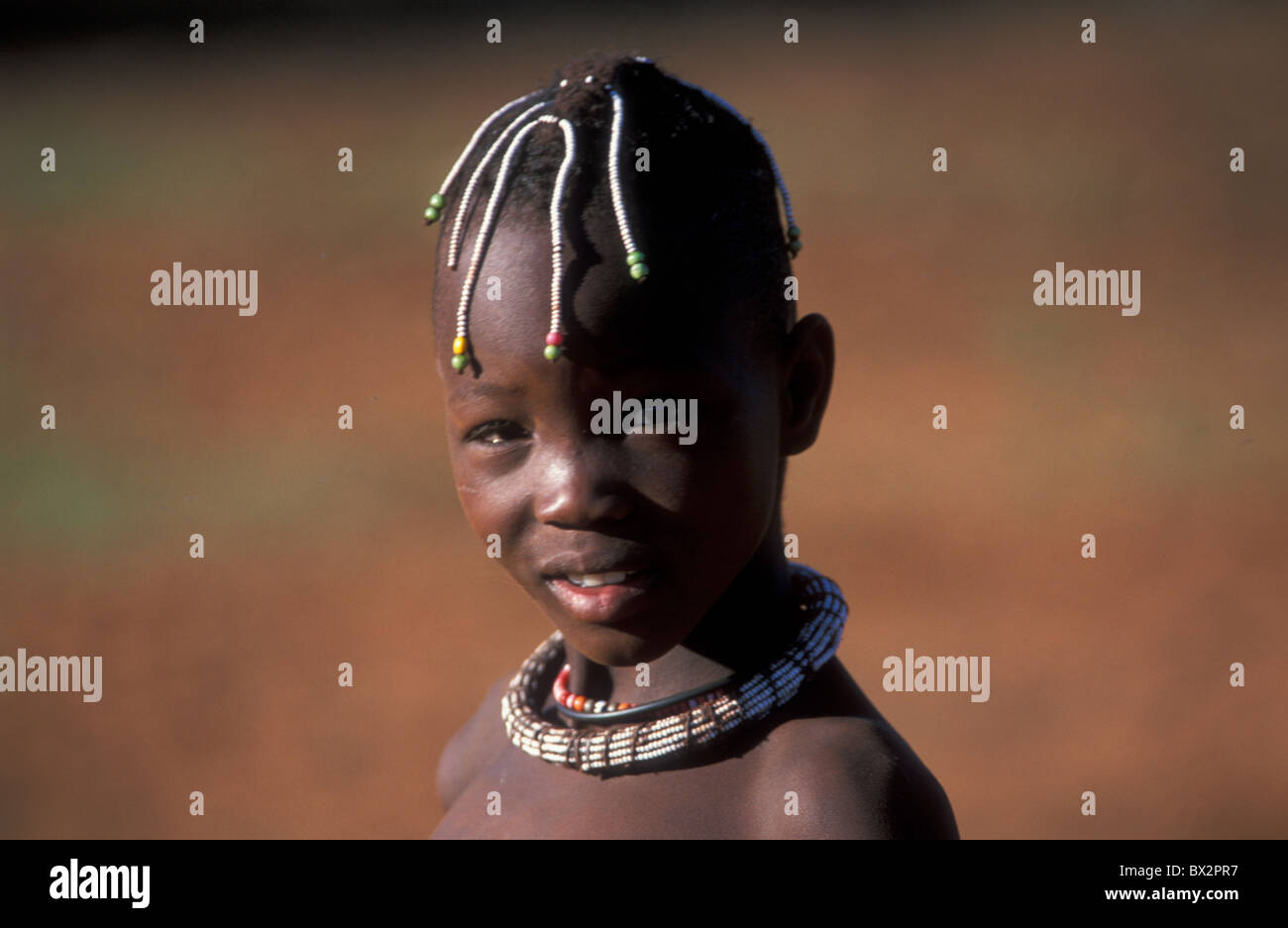 Africa beaded Boy hairbraids Himba Kaokoveld Namibia Africa necklace Ovahimba tribe Stock Photo