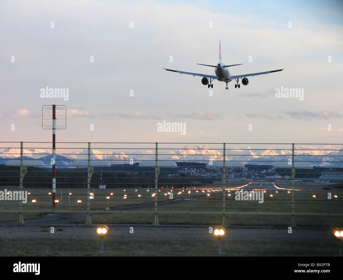 airplane jet jet airplane landing runway lights Befeuerung Zurich airport Switzerland Europe Alps dusk twi Stock Photo