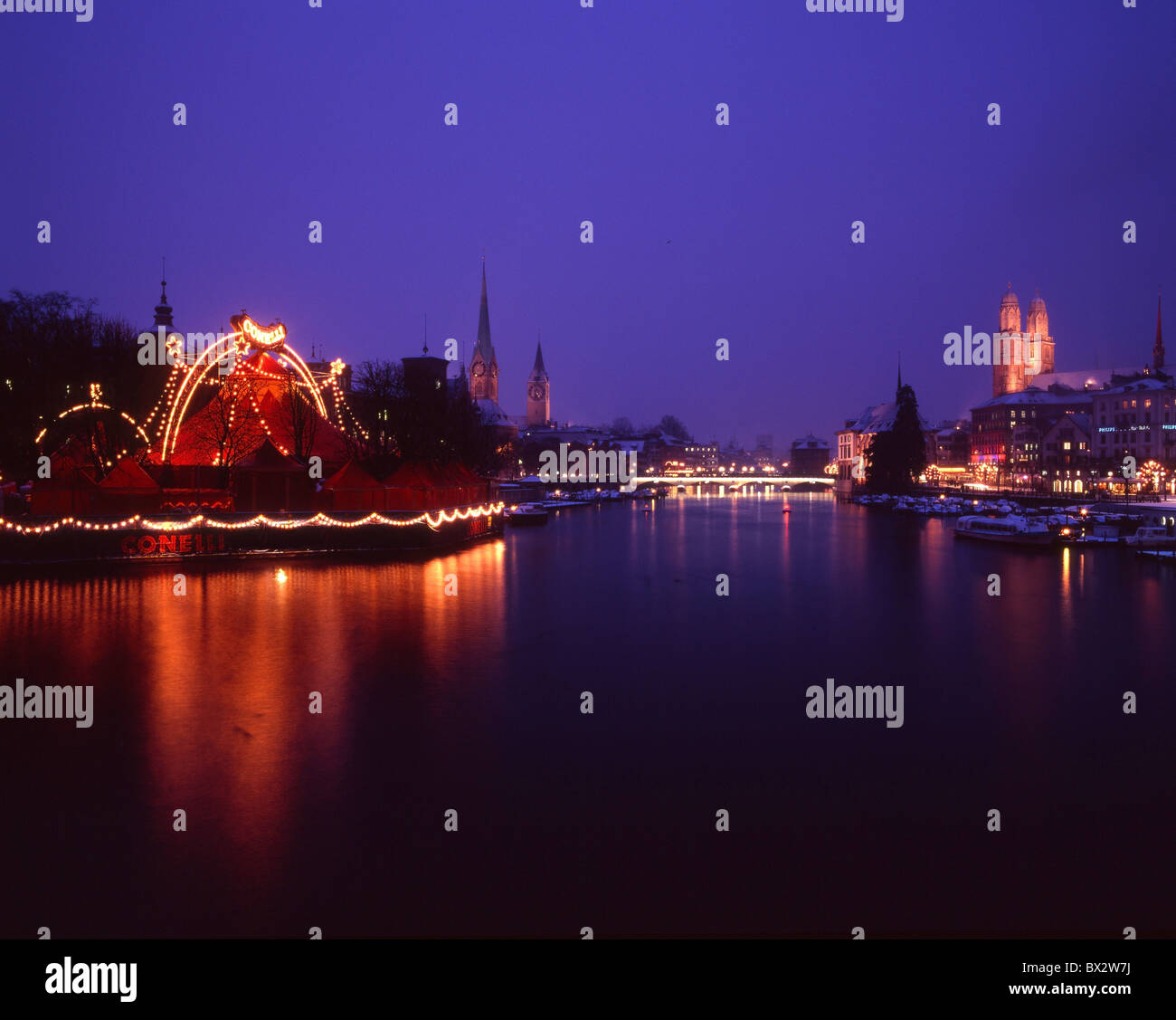 Zurich town city at night night Christmas winter Christmas lighting Grossmunster minster church Limmat Bau Stock Photo